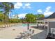 Inviting pool area with sun loungers, tables, and a view of surrounding trees at 5209 Woodlawn Dr, Durham, NC 27703