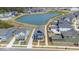 Areal view of neighborhood featuring a community pond and homes with attached rear garages at 5712 Agrinio Way, Raleigh, NC 27603