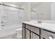 Bathroom featuring a tub and shower, toilet, dark vanity and a wide mirror at 5712 Agrinio Way, Raleigh, NC 27603