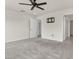 A blank canvas carpeted bedroom features a ceiling fan and multiple doorways offering versatility at 5712 Agrinio Way, Raleigh, NC 27603