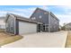 Rear exterior with long driveway and garage at 5712 Agrinio Way, Raleigh, NC 27603