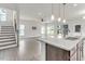 Open kitchen with granite countertops and island and attached living space at 5712 Agrinio Way, Raleigh, NC 27603