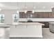 Kitchen island with stone countertops and pendant lighting at 5712 Agrinio Way, Raleigh, NC 27603