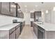 Bright kitchen with stainless steel appliances and an island overlooking the living area at 5712 Agrinio Way, Raleigh, NC 27603