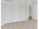 Spacious bedroom featuring plush carpeting, a closet, and a doorway at 5712 Agrinio Way, Raleigh, NC 27603