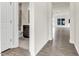 Hallway featuring sleek hardwood floors, a nearby bathroom, and lots of natural light at 5712 Agrinio Way, Raleigh, NC 27603