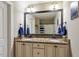 Bathroom featuring granite counters, double sinks and large framed mirror at 603 Goal Kick Dr, Fuquay Varina, NC 27526