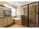 A well lit bathroom featuring a large mirror, granite countertops, a soaking tub, and a tiled glass shower at 603 Goal Kick Dr, Fuquay Varina, NC 27526