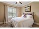 This bedroom features a ceiling fan, a picture window, carpeted floors, and a neutral color palette at 603 Goal Kick Dr, Fuquay Varina, NC 27526