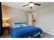 Cozy bedroom featuring carpet, a ceiling fan, and a charming ensuite bathroom at 603 Goal Kick Dr, Fuquay Varina, NC 27526