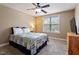 This bedroom features carpet, a ceiling fan, and a window with natural light at 603 Goal Kick Dr, Fuquay Varina, NC 27526