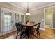 Bright dining area with hardwood floors, stylish lighting, and access to the outdoor patio at 603 Goal Kick Dr, Fuquay Varina, NC 27526