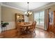 Warm and inviting dining area with hardwood floors, a wooden table set, and natural light from the window at 603 Goal Kick Dr, Fuquay Varina, NC 27526