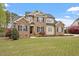 Charming two-story house features a lush green lawn, brick accents, and a welcoming front entrance at 603 Goal Kick Dr, Fuquay Varina, NC 27526