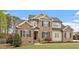 Beautiful two-story home with brick and siding, complemented by a well-manicured lawn and landscaping at 603 Goal Kick Dr, Fuquay Varina, NC 27526