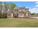 Inviting two-story home showcasing a green lawn, brick detailing, and a well-landscaped yard at 603 Goal Kick Dr, Fuquay Varina, NC 27526