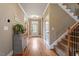 Inviting foyer with hardwood floors, staircase, and a view into other rooms, creating a warm welcome at 603 Goal Kick Dr, Fuquay Varina, NC 27526