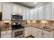 Modern kitchen boasts granite counters, stainless appliances, and ample storage in classic white cabinets at 603 Goal Kick Dr, Fuquay Varina, NC 27526