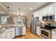 Well-equipped kitchen features stainless steel appliances, granite counters, and ample cabinetry at 603 Goal Kick Dr, Fuquay Varina, NC 27526