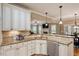 Granite counters highlight this open concept kitchen with stainless appliances and lots of cabinets at 603 Goal Kick Dr, Fuquay Varina, NC 27526