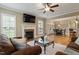 Spacious living room with fireplace, hardwood floors, and an open layout to the dining area at 603 Goal Kick Dr, Fuquay Varina, NC 27526