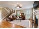 Bright living room with staircase, featuring hardwood floors, a fireplace, and comfortable seating at 603 Goal Kick Dr, Fuquay Varina, NC 27526