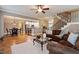 Open-concept living area showcases hardwood floors, a staircase, and a view into the updated kitchen at 603 Goal Kick Dr, Fuquay Varina, NC 27526