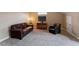 Living room boasts a comfortable leather sofa, soft carpet, and neutral wall tones at 603 Goal Kick Dr, Fuquay Varina, NC 27526