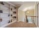 A landing featuring built in shelving, carpet, and views of the staircase at 603 Goal Kick Dr, Fuquay Varina, NC 27526