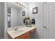 Bathroom with a large countertop and mirror, wood vanity, and fresh neutral paint at 622 Twain Town Dr, Knightdale, NC 27545