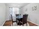 Bright dining area with a glass-top table and seating for four on hardwood floors at 622 Twain Town Dr, Knightdale, NC 27545