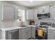 Modern kitchen boasts stainless steel appliances, bright countertops and tiled backsplash at 622 Twain Town Dr, Knightdale, NC 27545