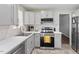 Modern kitchen boasts stainless steel appliances, bright countertops and tiled backsplash at 622 Twain Town Dr, Knightdale, NC 27545