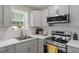 Updated kitchen featuring stainless steel appliances, countertops and white-tiled backsplash at 622 Twain Town Dr, Knightdale, NC 27545