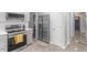 Modern kitchen with stainless steel refrigerator, tiled backsplash and gray cabinetry at 622 Twain Town Dr, Knightdale, NC 27545