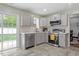 Updated kitchen featuring stainless steel appliances, light gray cabinets, and stylish backsplash at 622 Twain Town Dr, Knightdale, NC 27545