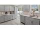 Bright kitchen with modern gray cabinets, stainless appliances, and a sliding glass door to the outdoors at 622 Twain Town Dr, Knightdale, NC 27545