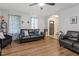 Comfortable living room features a leather sofa, decorative pillows, and a view of the front entrance at 622 Twain Town Dr, Knightdale, NC 27545