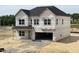 Unfinished two-story home with large windows and attached two-car garage at 705 Compeer Way # 31, Rolesville, NC 27571