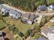 An aerial view shows a home with lush green lawn and mature trees in a well-maintained residential area at 7825 Green Hope School Rd, Cary, NC 27519