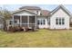 Lovely screened porch overlooks the well-manicured lawn and mature landscaping in the backyard of this charming home at 7825 Green Hope School Rd, Cary, NC 27519