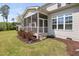 Charming screened porch provides a serene view of the manicured lawn and landscaping in the backyard at 7825 Green Hope School Rd, Cary, NC 27519