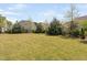 Well-maintained backyard featuring a spacious lawn and mature trees, offering ample space for outdoor activities at 7825 Green Hope School Rd, Cary, NC 27519