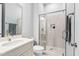 This bathroom features a marble sink, walk-in shower and updated faucet with modern, neutral tones at 7825 Green Hope School Rd, Cary, NC 27519