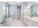 This bathroom offers double vanity sinks, a walk-in shower and soaking tub with modern, neutral tones at 7825 Green Hope School Rd, Cary, NC 27519