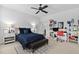 Bright bedroom featuring a large bed, ceiling fan, desk area, and plenty of shelving at 7825 Green Hope School Rd, Cary, NC 27519