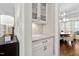 Butler's pantry boasts marble countertops, white cabinets, and views to the dining room at 7825 Green Hope School Rd, Cary, NC 27519