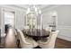 Bright dining room with hardwood floors, white trim, display cabinet, and modern light fixture at 7825 Green Hope School Rd, Cary, NC 27519
