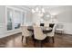 Dining room features hardwood floors, plantation shutters, decorative mirror, and modern chandelier at 7825 Green Hope School Rd, Cary, NC 27519