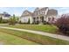 Beautifully landscaped two-story home featuring a stone facade, covered porch, and well-maintained lawn at 7825 Green Hope School Rd, Cary, NC 27519